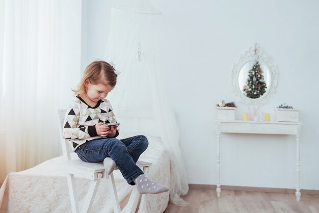 Child in soft warm pajama playing in bed