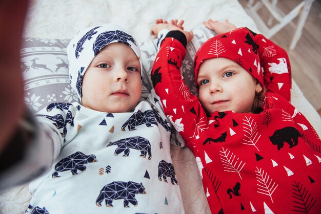 Child in soft warm pajama playing in bed