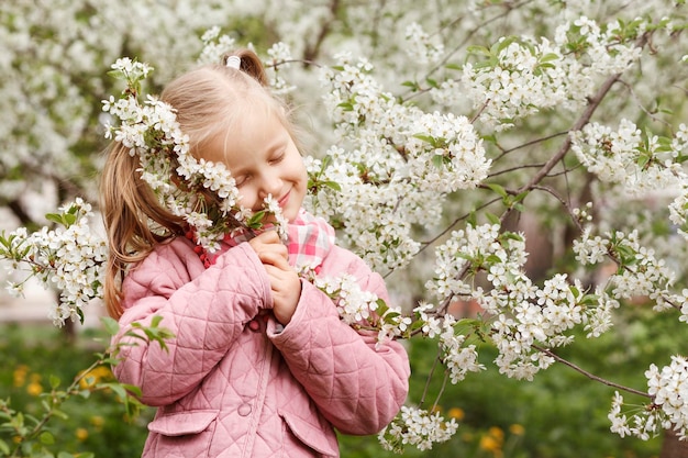 Child spring garden Little girl blossoming cherry branch dreams