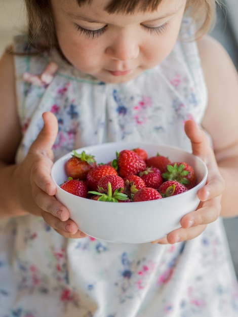 Child and strawberry