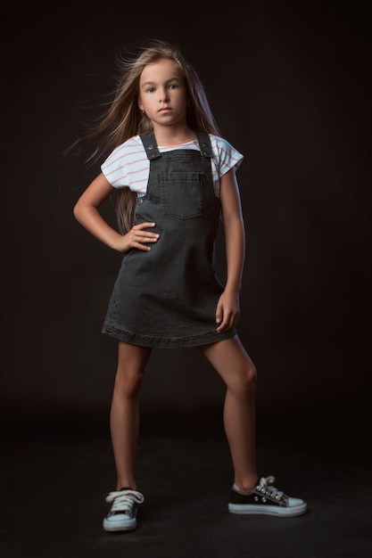 The child in the Studio posing in fashionable clothes