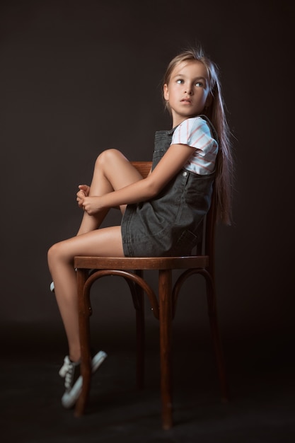 The child in the Studio posing in fashionable clothes