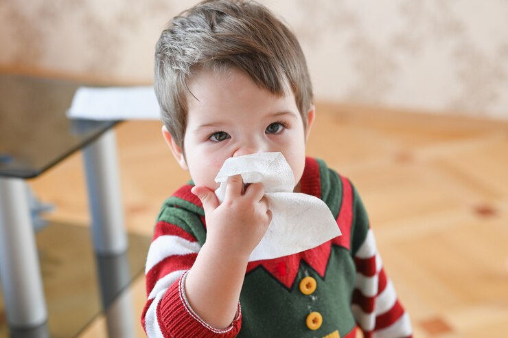Child suffering from running nose or sneezing. Allergic little boy