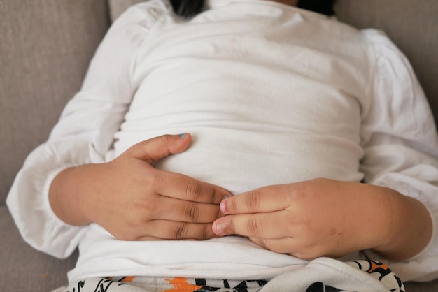 child suffering stomach pain close up