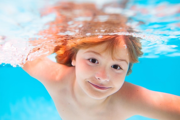 Child swim and dive underwater in the swimming pool kids swim on summer vacation