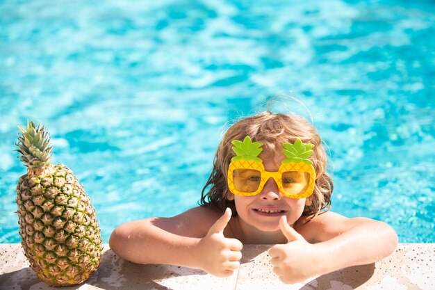 Child in swimming pool Summer activity Healthy kids lifestyle Summer pineapple fruit