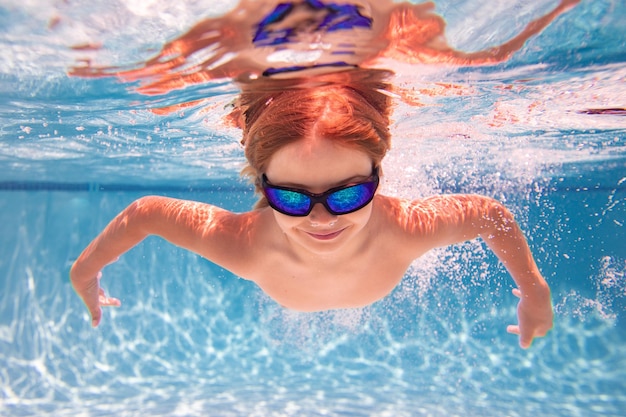 Child in swimming pool underwater kid underwater swim child splashing underwater in swimming pool ac