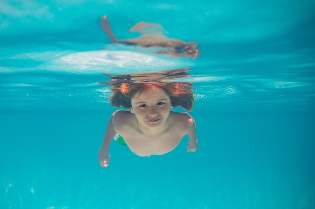 Child in swimming pool underwater kid underwater swim child splashing underwater in swimming pool