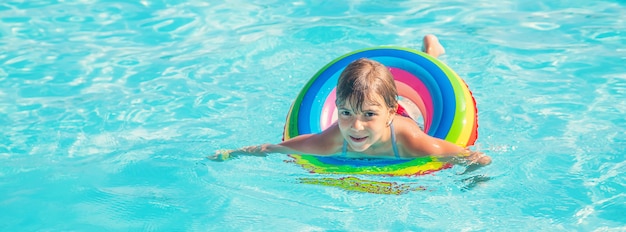 The child swims and dives in the pool. 