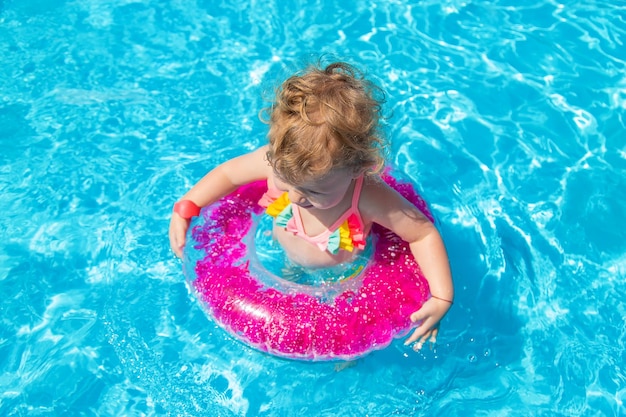 A child swims in a pool with a circle Selection focus