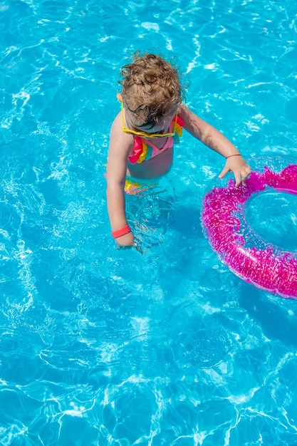 A child swims in a pool with a circle Selection focus