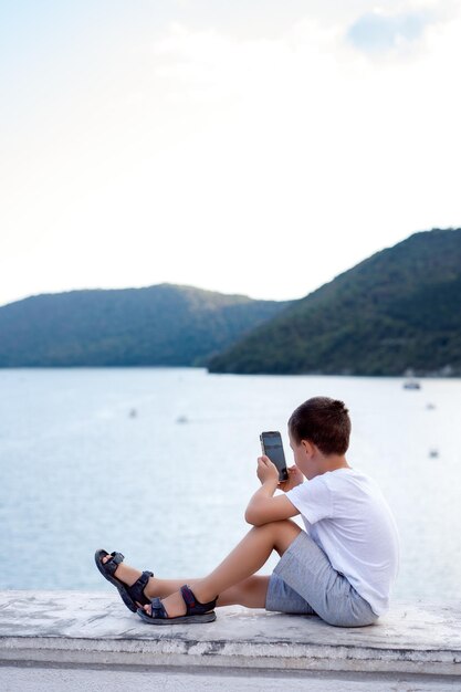 child taking pictures of scenic view travel and outdoor activities