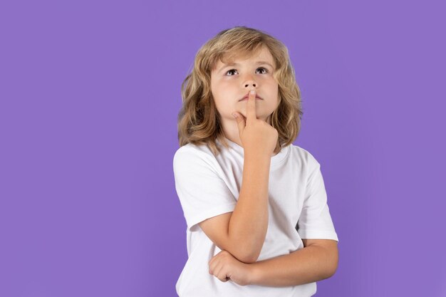 Photo child thinking on isolated background think and idea thoughtful kid studio portrait doubt and