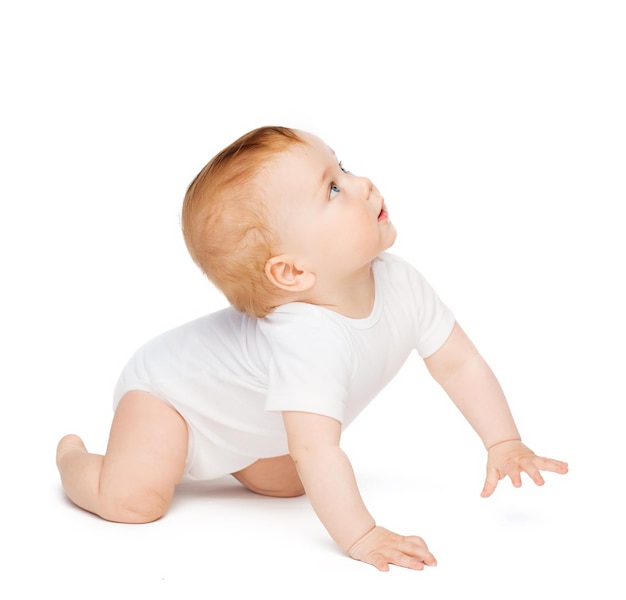 Photo child and toddler concept - crawling curious baby looking up