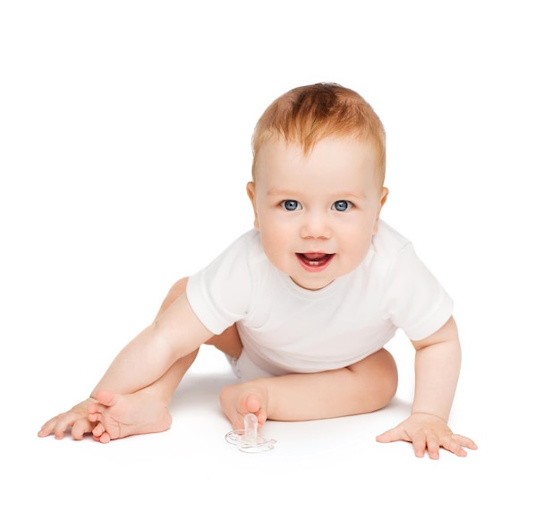 child and toddler concept - smiling baby sitting on the floor