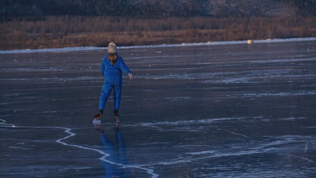 The child train on ice professional speed skating The girl skates in the winter in sportswear sport glasses suit Outdoor slow motion