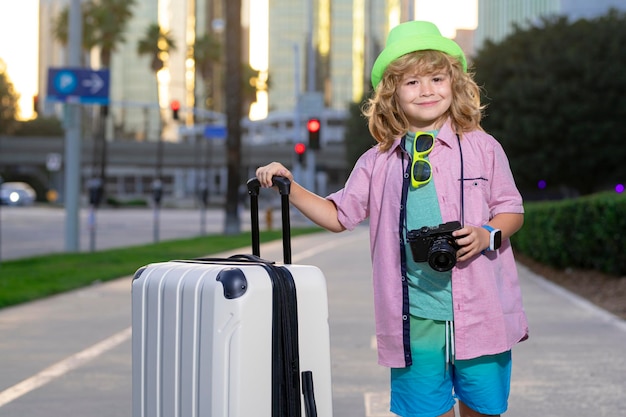 Child traveler with travel bag outdoor Kids tourism