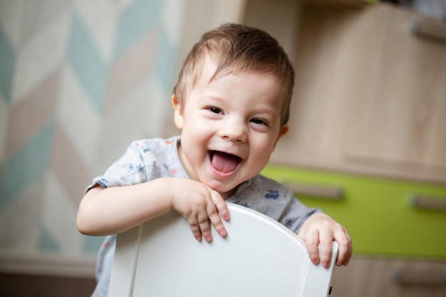 The child tries to climb into the chair