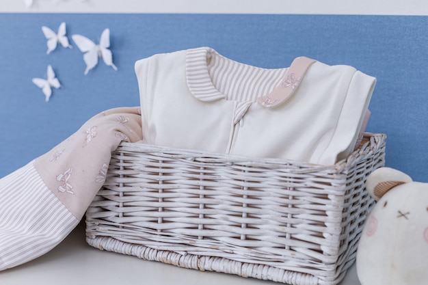 Photo child trunk with a big teddy bear and girl dresses.