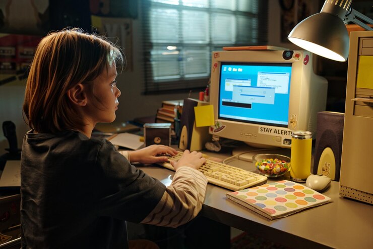 Photo child using computer in home office setting