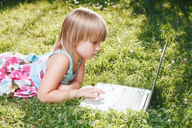 Photo child using a laptop homeschooling during selfisolation