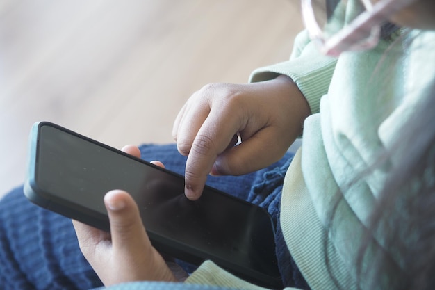 child using a smartphone to interact with a digital application