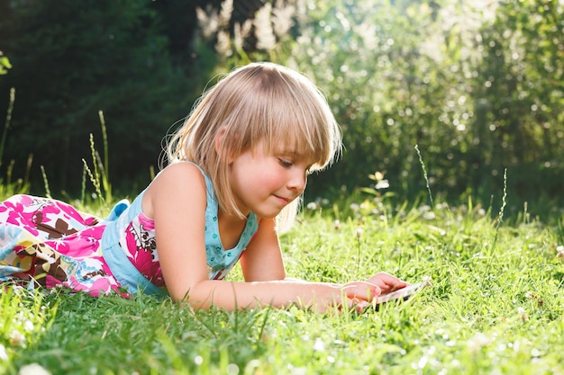 Child using a tablet computer during online lesson being on selfisolation