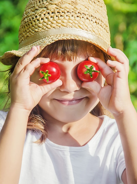 Child and vegetables on the farm. Selective focus. nmature.