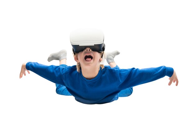 Child in virtual reality glasses soars isolated on white surface. Virtual reality games, VR glasses.