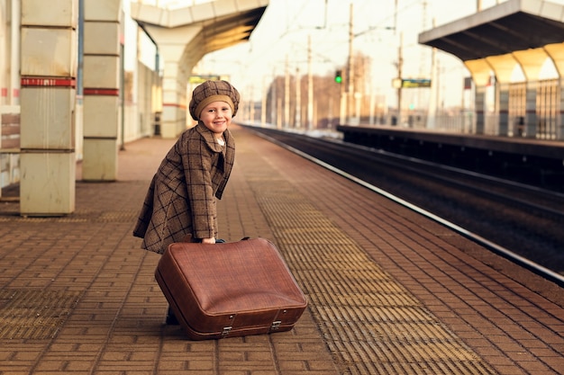 Child waiting for a train at station