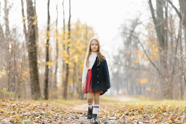 Child on a walk in the autumn park.