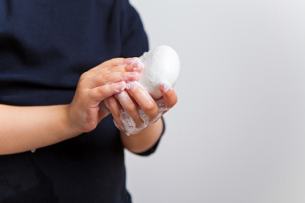 the child washes his hands thoroughly with soap. Instructions on how to wash your hands