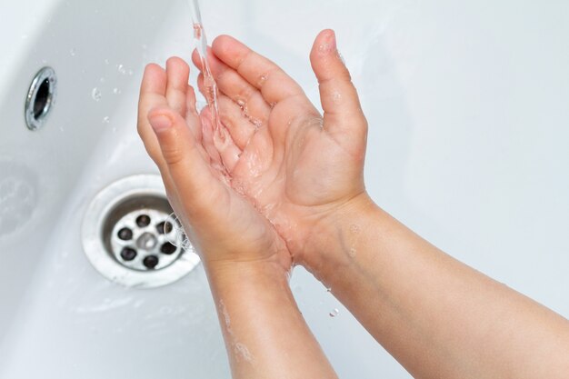 Child washing his hands