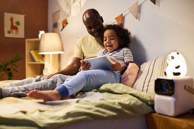 Child watching cartoon with his dad