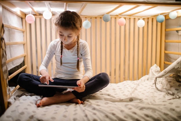 Child watching tablet pc at home.