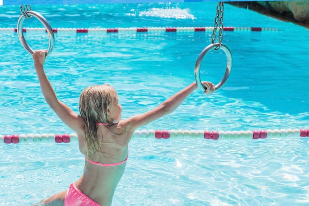 Child on water slide at aquapark. Summer holiday.