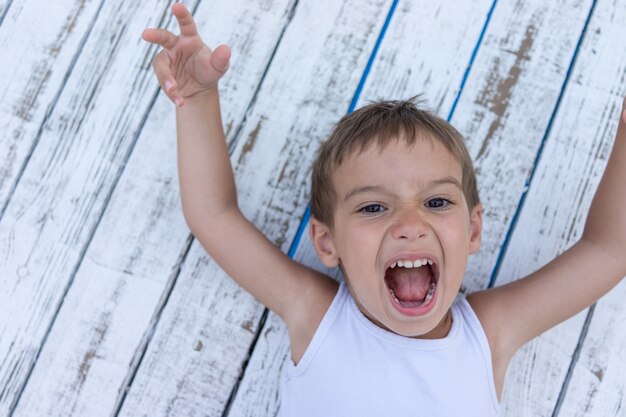 Child on white wooden background