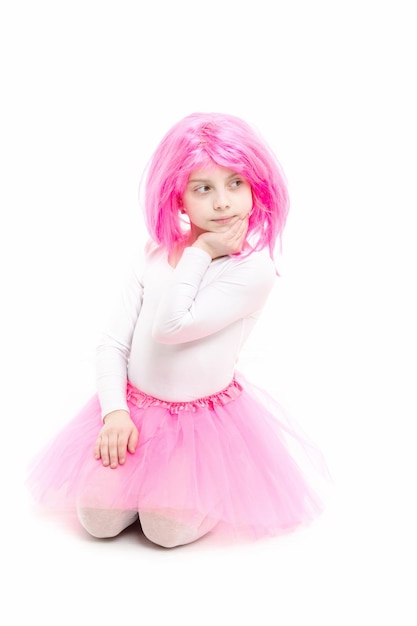 Child in wig isolated on white background Small girl t in pink skirt beauty and fashion ballet and art Childhood and happiness