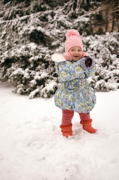 a child in a winter park rejoices