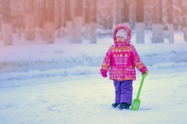 Child in winter park with copy space