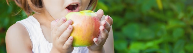 Child with an apple. photo. nature