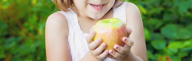 Child with an apple. photo. nature