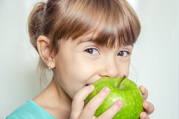 Child with an apple. Selective focus. nature