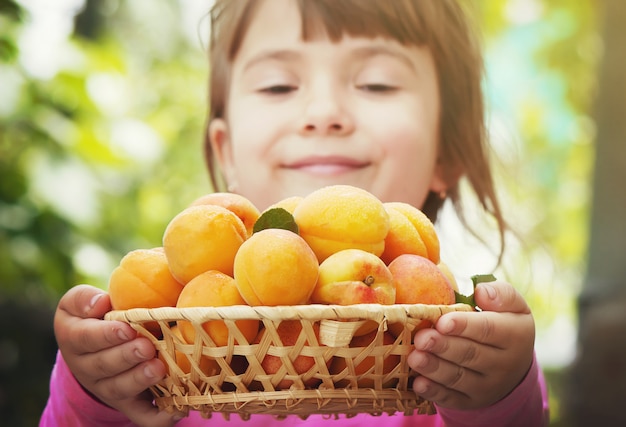 Child with apricots. 