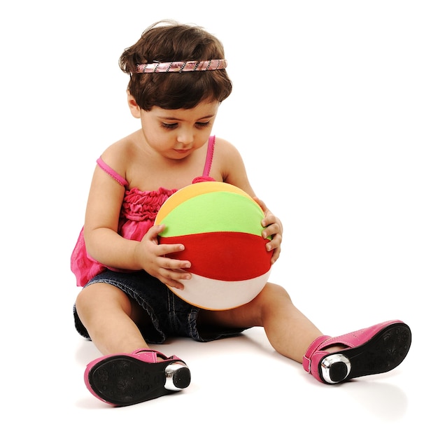 Child with beach ball over white background