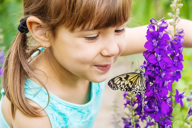 Child with a butterfly. Idea leuconoe. Selective focus.