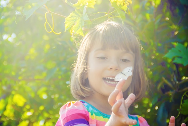 Child with a butterfly. Selective focus. nature.