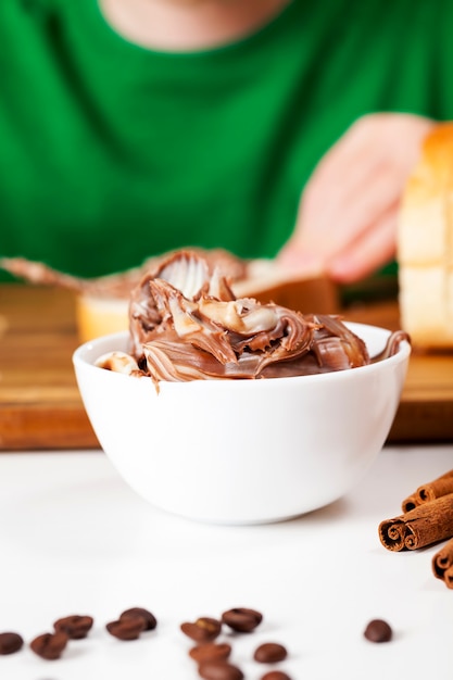 Child with chocolate paste and a loaf