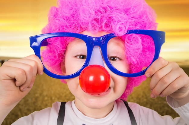 child with clown glasses