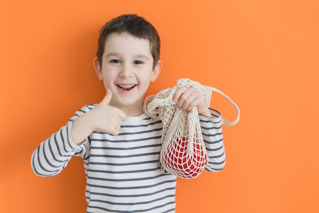 Child with eco bag with vegetables